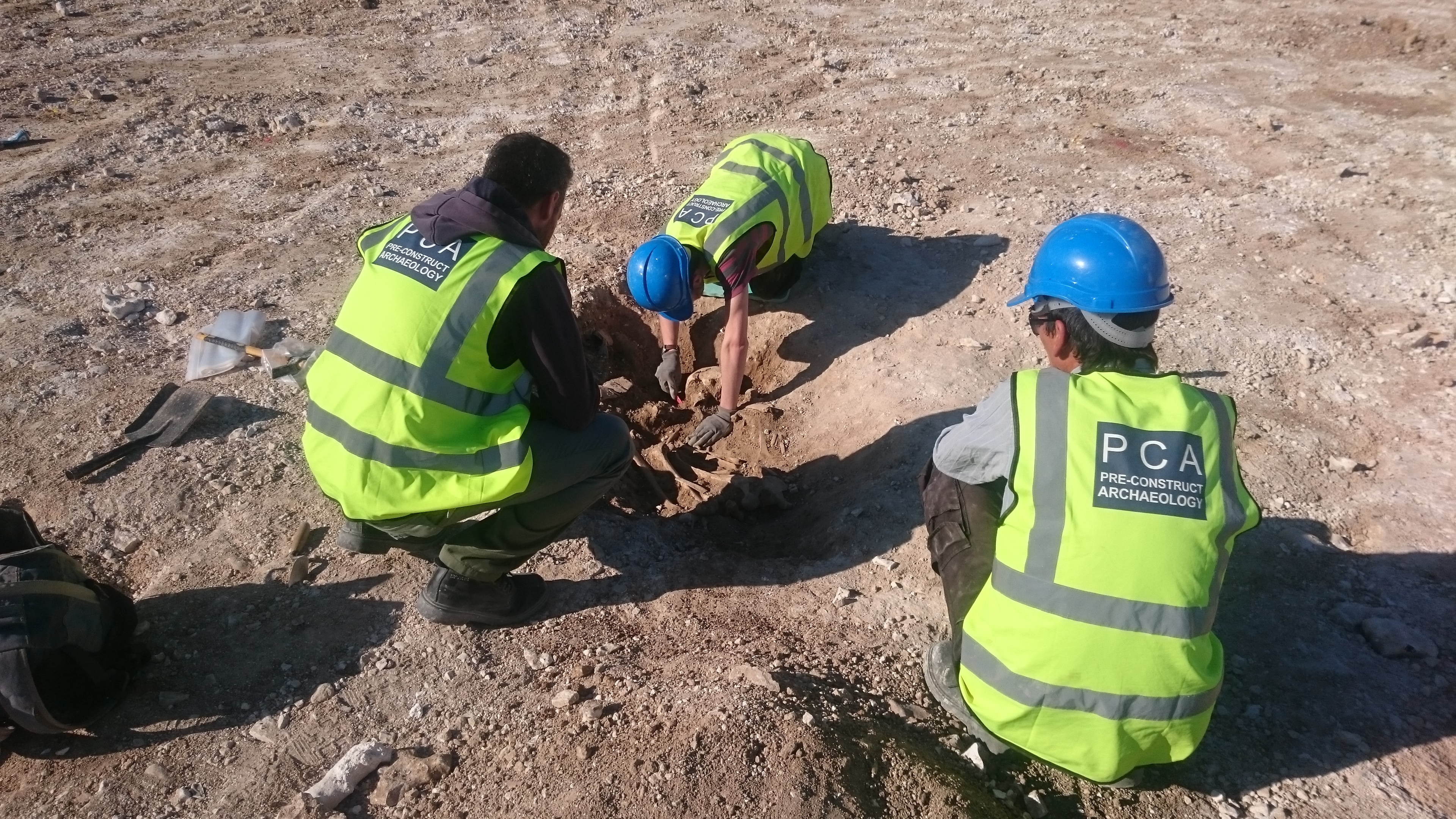 Three men in a pit